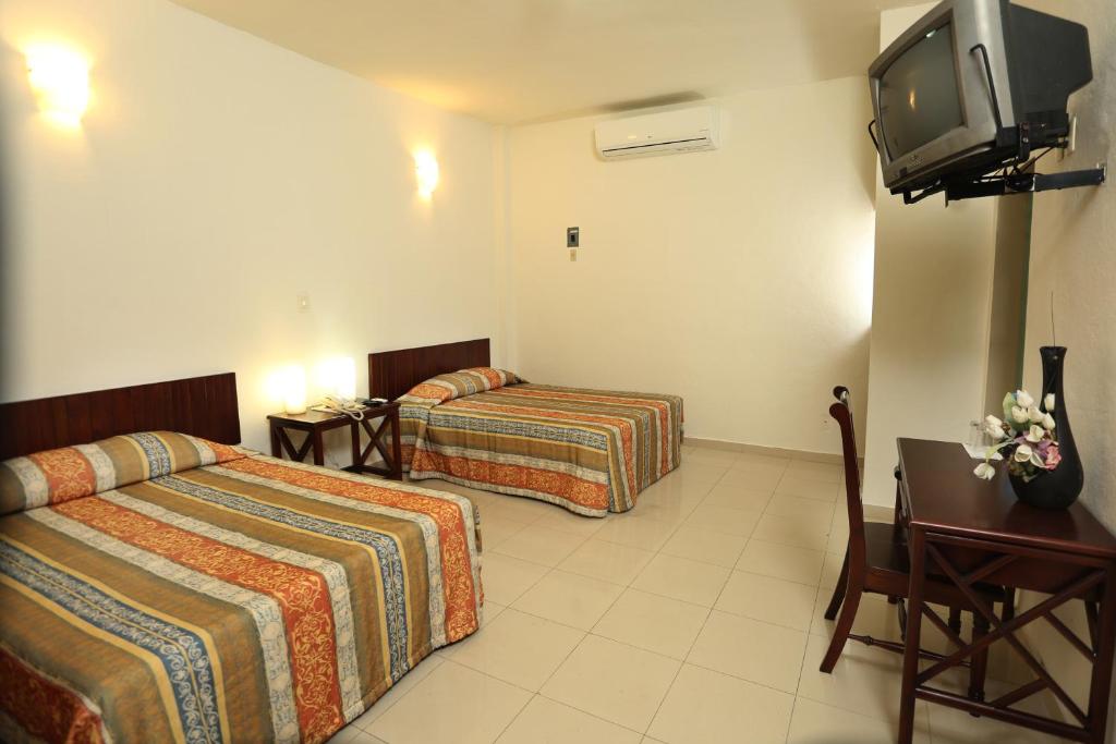 Postel nebo postele na pokoji v ubytování Hotel Marel