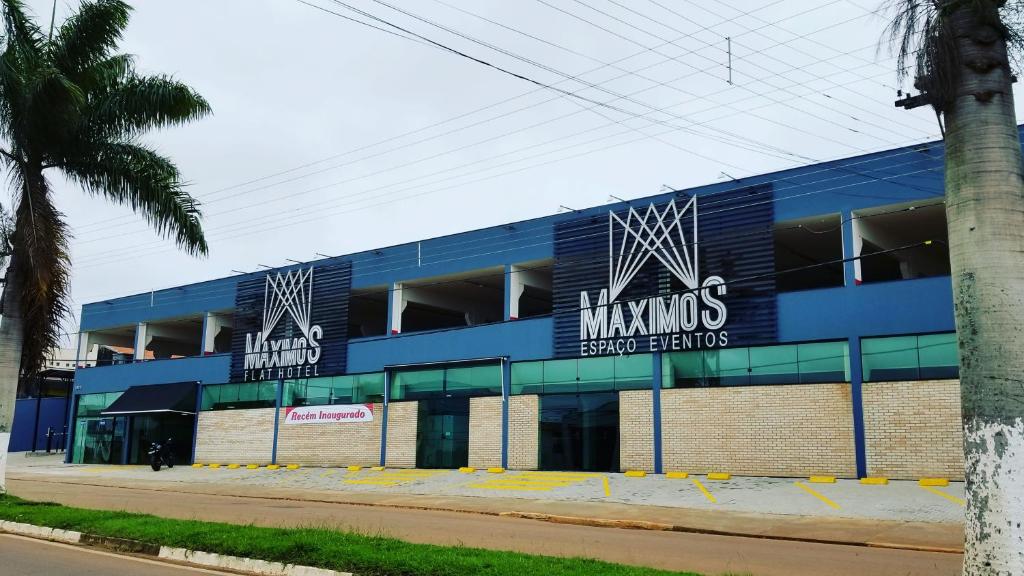 a blue building with signs on the side of it at Hotel Máximos in Itapetininga