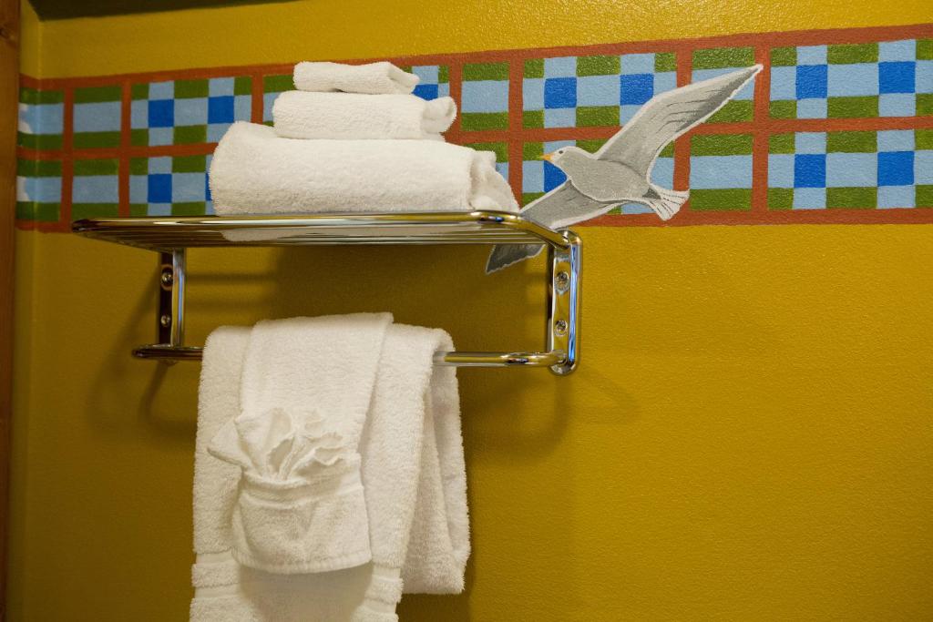 a towel rack with towels and a bird on it at McMenamins Gearhart Hotel in Gearhart