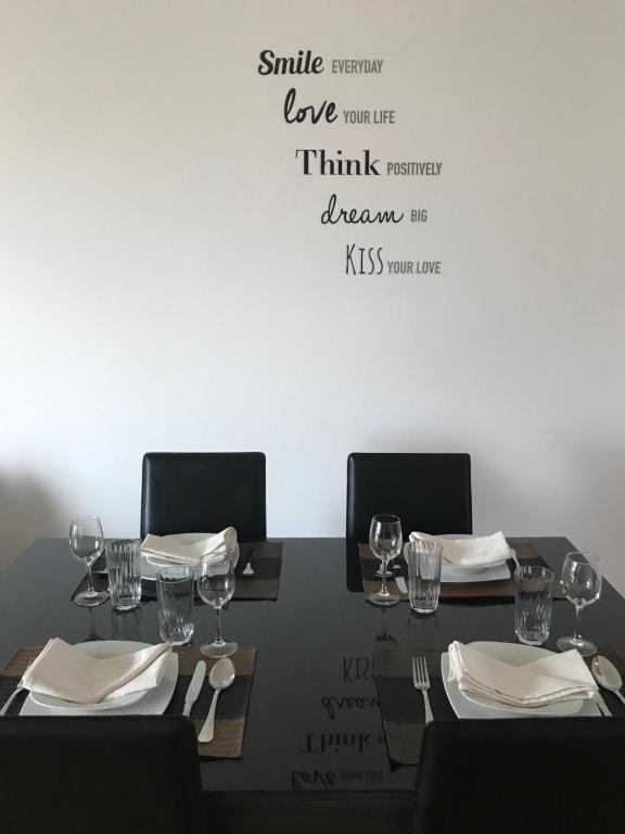 a table with chairs and wine glasses on it at Lou-Jos in Funchal