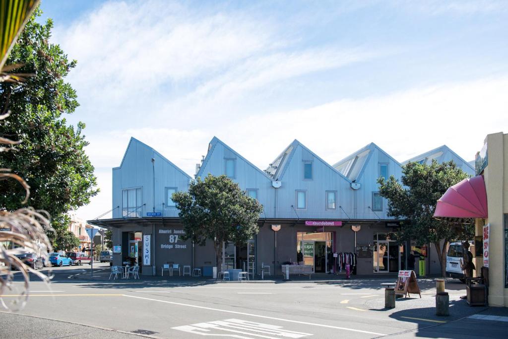 a street in a town with blue buildings at Luxurious Loft Apartments in the heart of Ahuriri in Napier