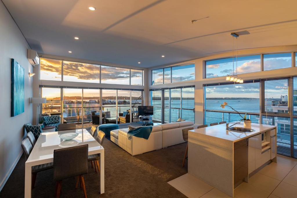 a living room with a view of the ocean at Princes Wharf's truly stunning North-West Loft in Auckland