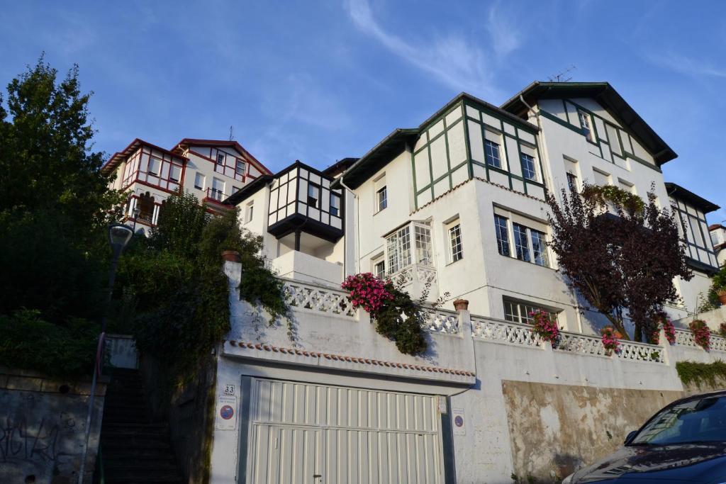 un edificio blanco con una puerta y una valla en Estudio a 5 min Guggenheim en Bilbao