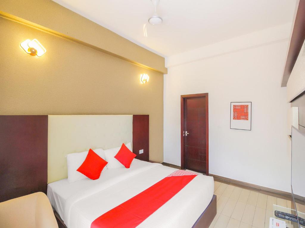 Postel nebo postele na pokoji v ubytování Samudra Mysore