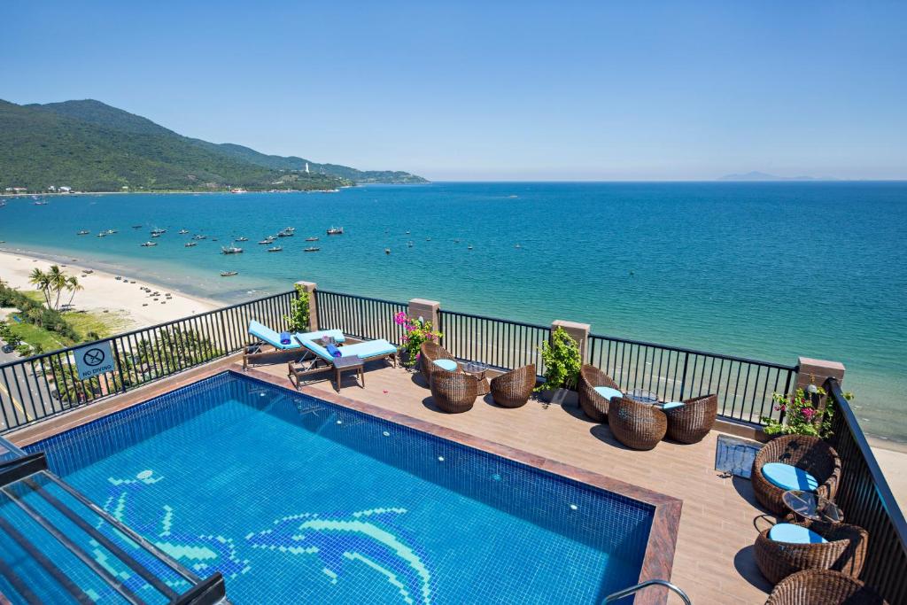 a swimming pool on a balcony with a view of the beach at Seashore Hotel & Apartment in Da Nang