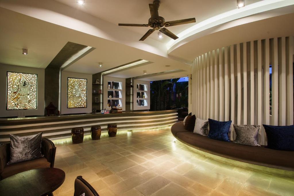 a lobby with chairs and a ceiling fan at Apsara Residence Hotel in Siem Reap