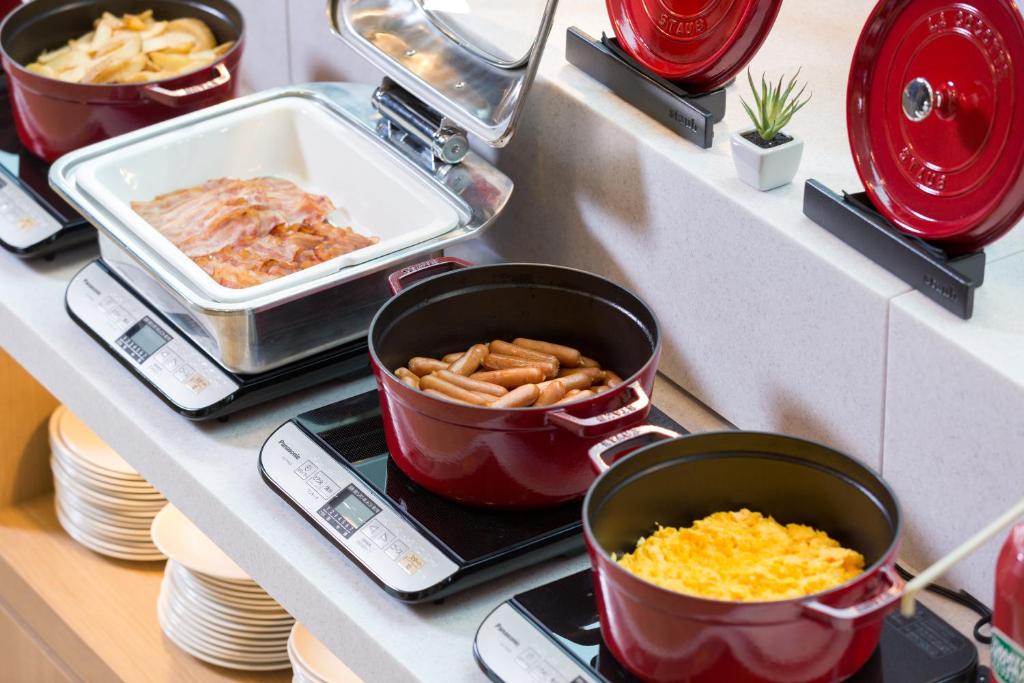 a kitchen counter with pots and pans of food at Centrair Hotel in Tokoname