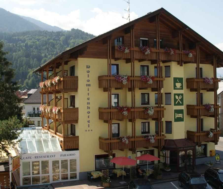 a large building with balconies on the side of it at Dolomitenhotel Lienz in Lienz