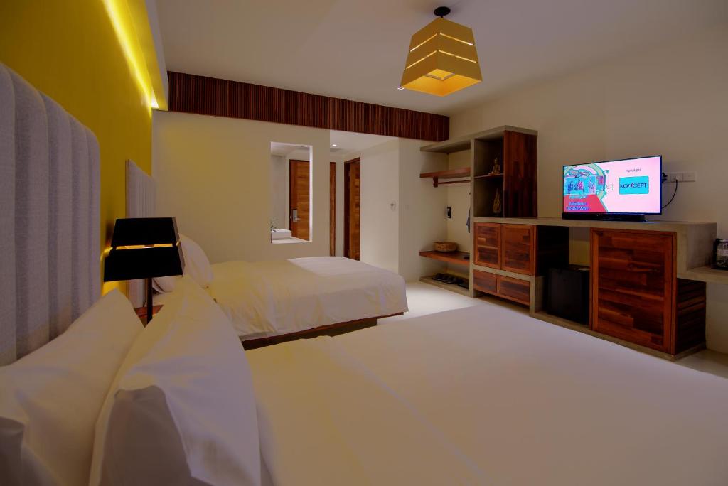 a bedroom with a bed and a flat screen tv at Apsara Residence Hotel in Siem Reap