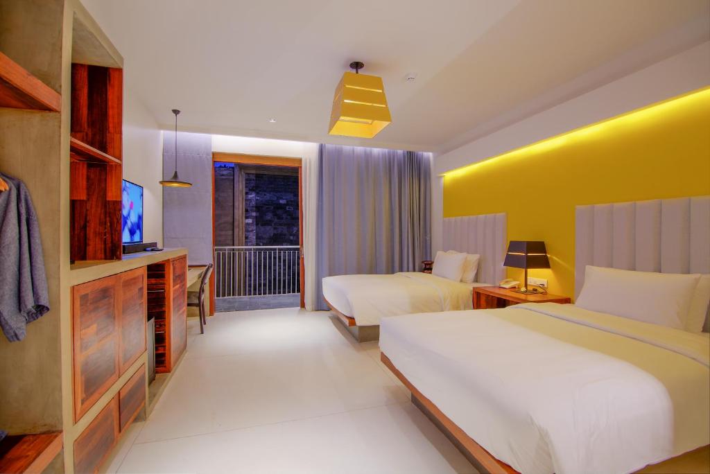 a hotel room with two beds and a television at Apsara Residence Hotel in Siem Reap