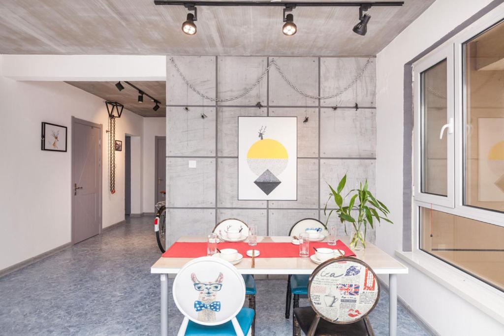 a dining room with a table and two chairs at Dalian Jinzhou·Baisheng Shopping Mall· Locals Apartment 00165460 in Jinzhou