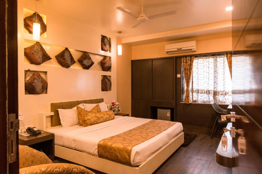 Hotel Buddha tesisinde bir odada yatak veya yataklar