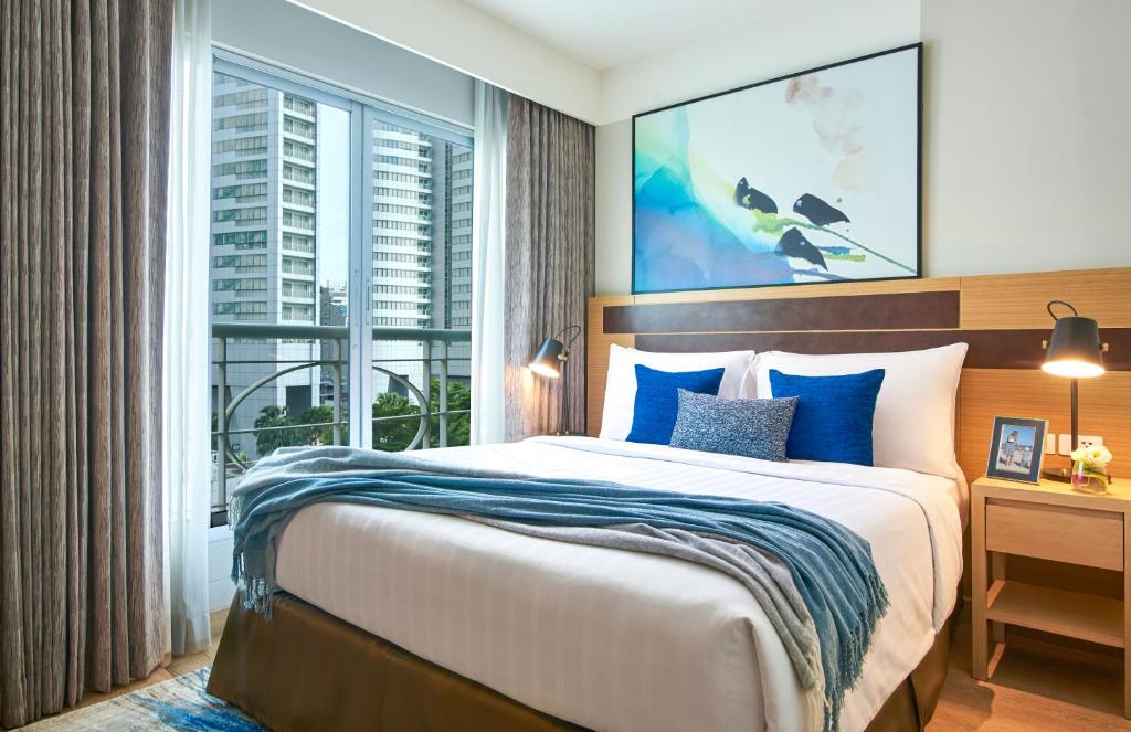Postel nebo postele na pokoji v ubytování Shama Lakeview Asoke Bangkok