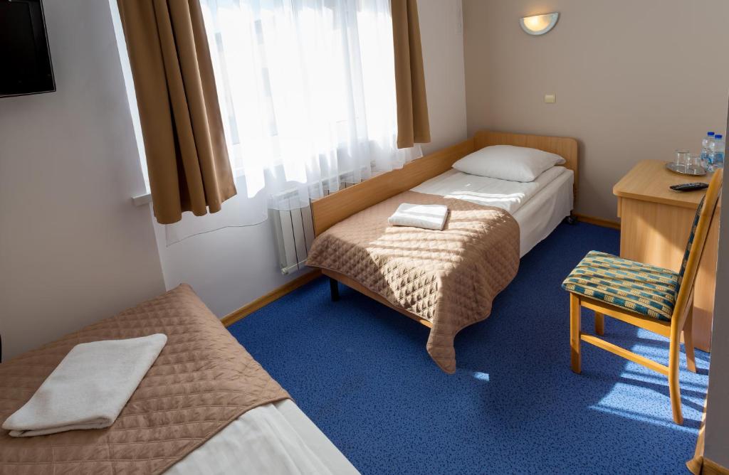 Postel nebo postele na pokoji v ubytování Kompleks Hotelowy Logos