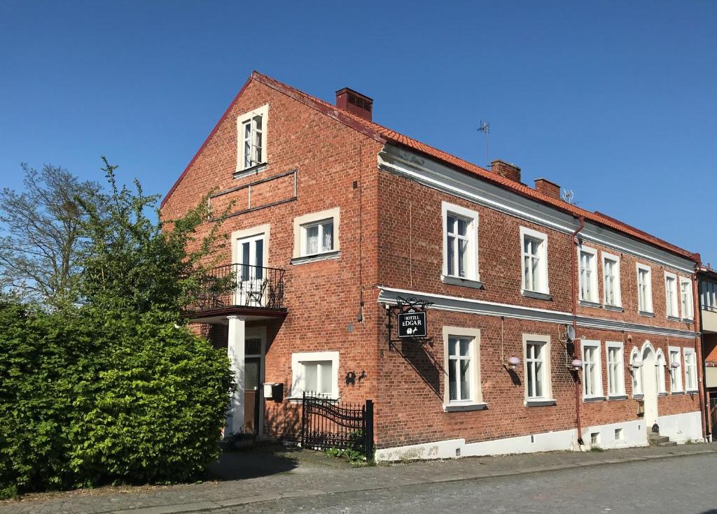 
a brick building with a clock on the front of it at Hotell Edgar & Lilla Kök in Sölvesborg
