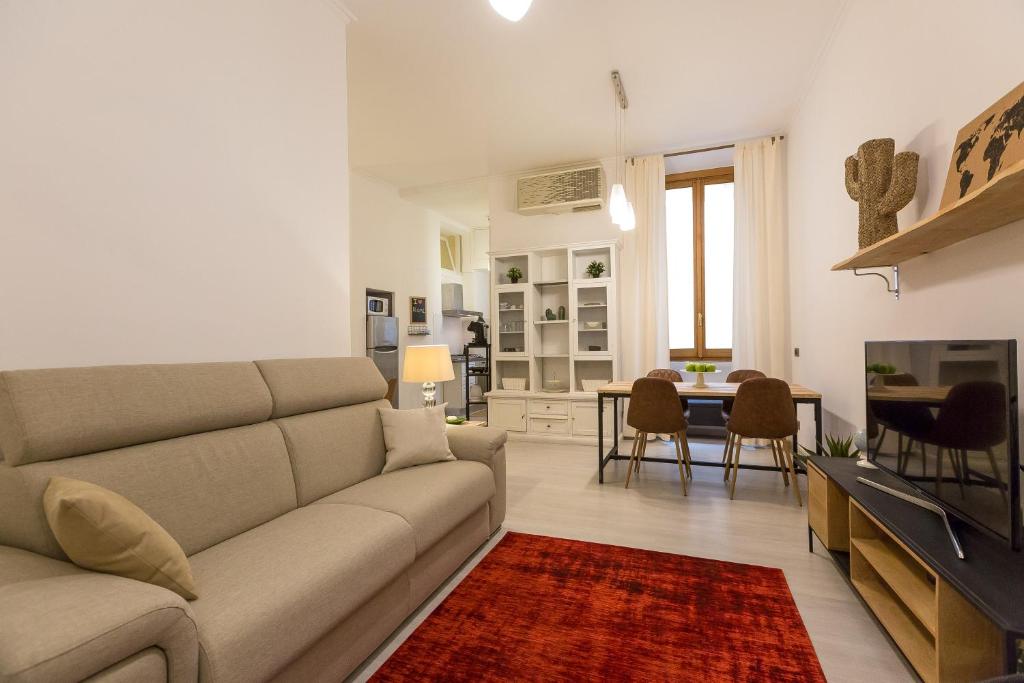 a living room with a couch and a dining room at Lovely New home, Trastevere! in Rome