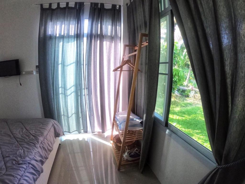 Postel nebo postele na pokoji v ubytování ComeHome Lamphun