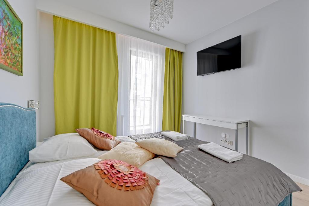 Posteľ alebo postele v izbe v ubytovaní Staywin Apartments Chmielna Park