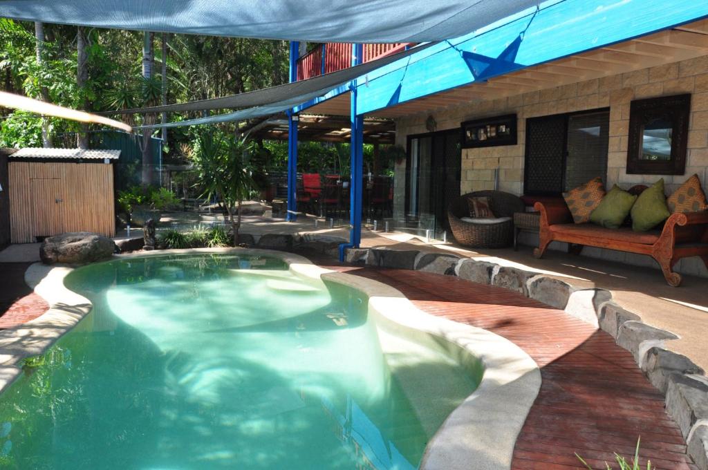 a swimming pool in the middle of a patio at Double Island Dream in Rainbow Beach