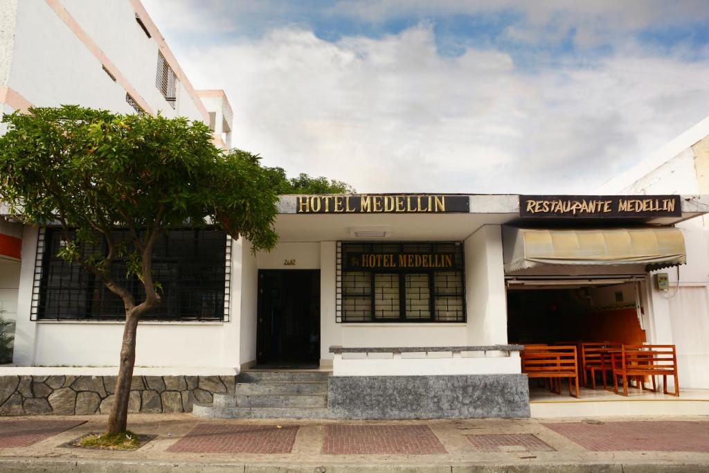 a building with a tree in front of it at Hotel Medellin in Santa Marta