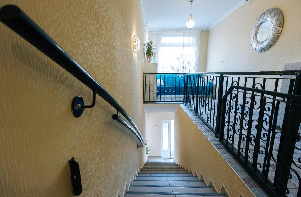 a staircase in a house with a stair railing at Páva Panzió in Soltvadkert