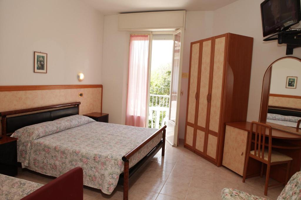Postel nebo postele na pokoji v ubytování Hotel Parigi