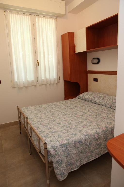 Postel nebo postele na pokoji v ubytování Hotel Parigi