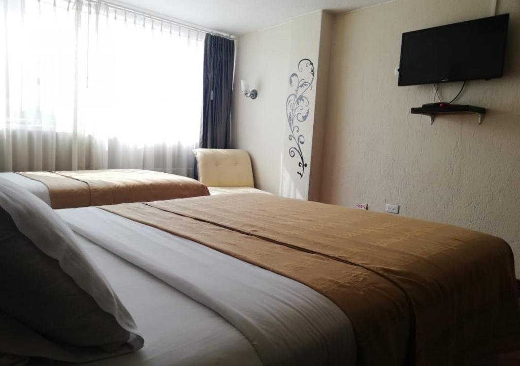 Postel nebo postele na pokoji v ubytování Hostal Capri