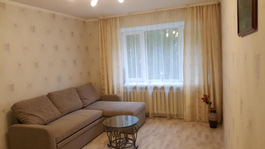 a living room with a couch and a window at Gerassimovi 14 apartment in Narva