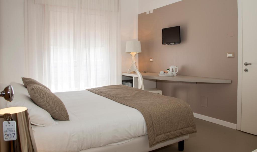 Postel nebo postele na pokoji v ubytování Hotel Arizona