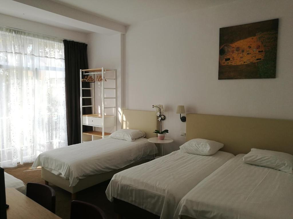 Postel nebo postele na pokoji v ubytování New City Hotel Scheveningen