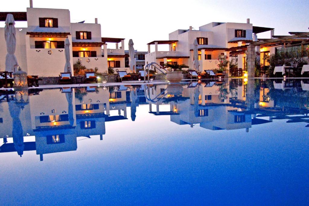 a view of a pool of water in front of houses at Vina Beach Hotel in Skiros