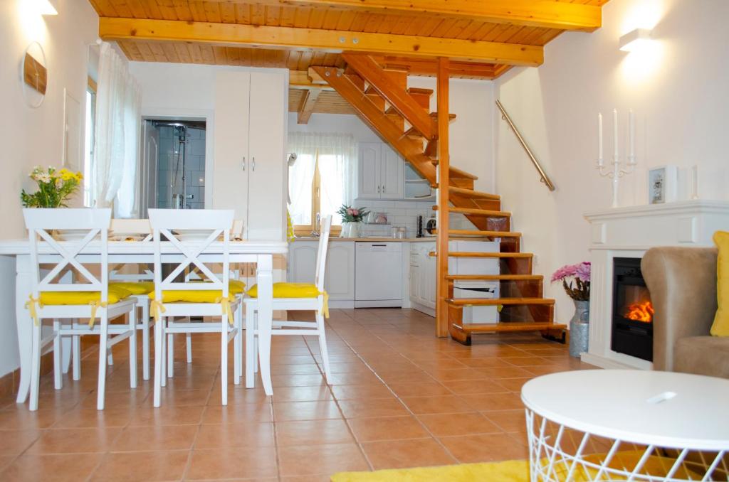a kitchen and living room with a table and chairs at 54 Green Road Varaždin in Kućan Marof