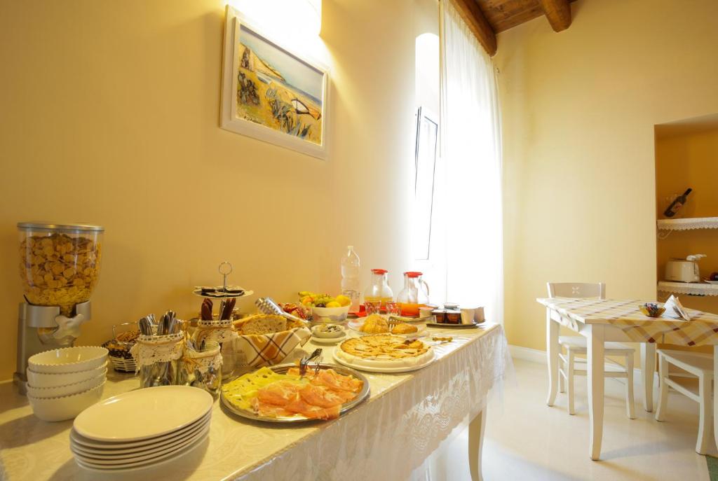 a kitchen with a table with plates of food on it at B&B Monsignore in Vieste