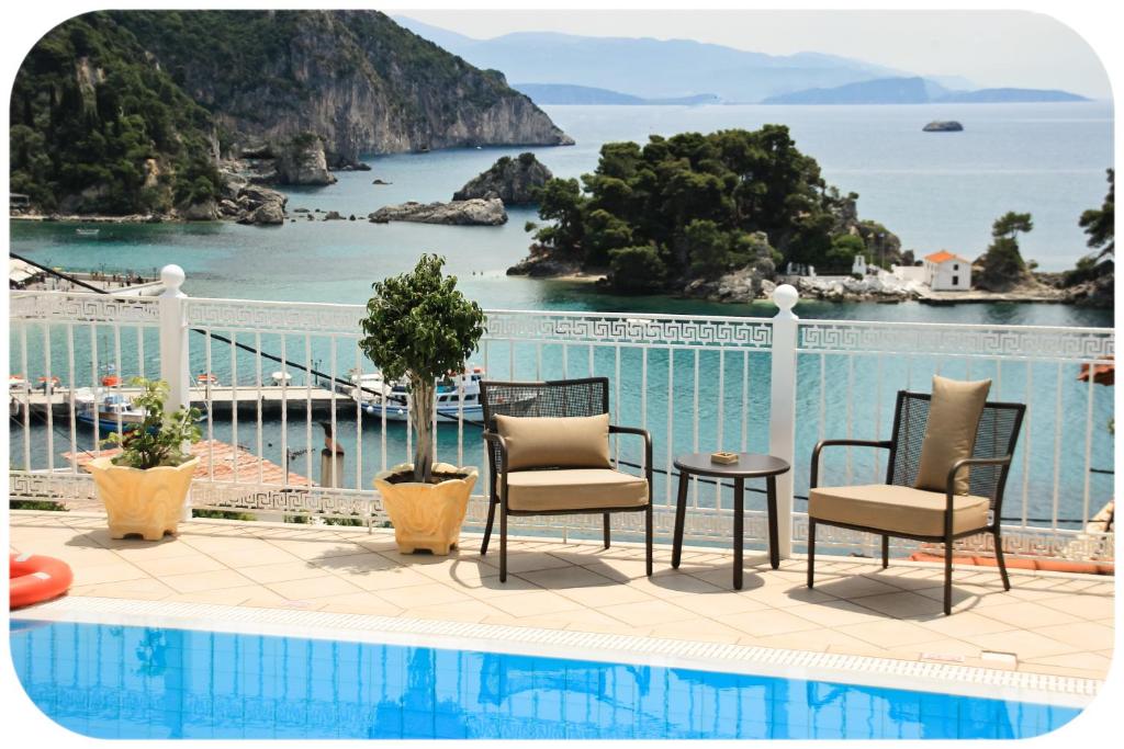 a patio with chairs and a table next to a pool at Altanahouse in Parga