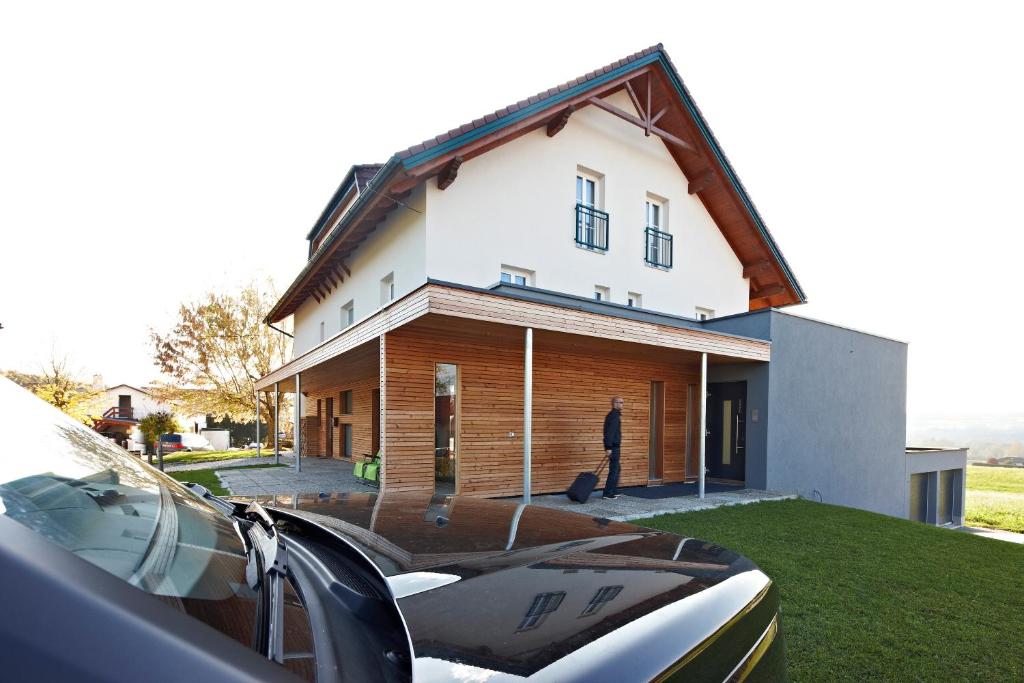 a man standing in front of a house at Pension Jageredt in Nussbach