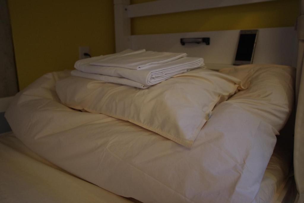 Postel nebo postele na pokoji v ubytování Cinnamon Guesthouse Dogo