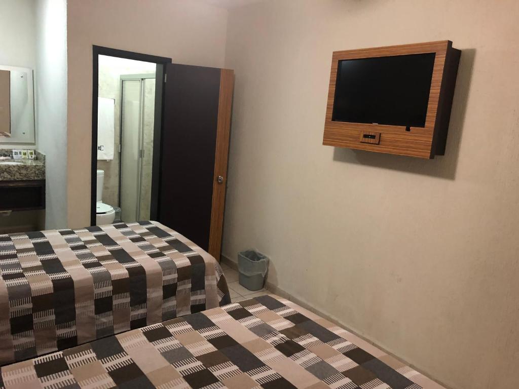 Postel nebo postele na pokoji v ubytování Hotel del Carmen