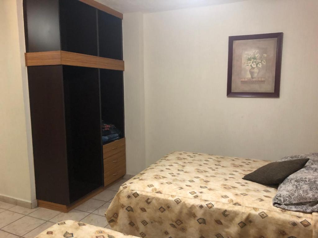 Postel nebo postele na pokoji v ubytování Hotel del Carmen