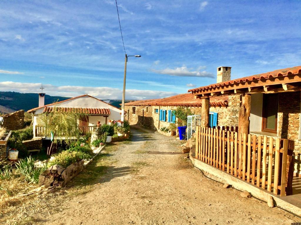 un camino de tierra entre dos casas con una valla en Mosteirinho, en Negreda