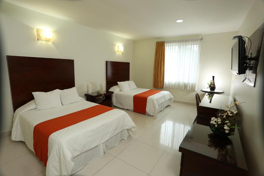 Postel nebo postele na pokoji v ubytování Hotel Marel