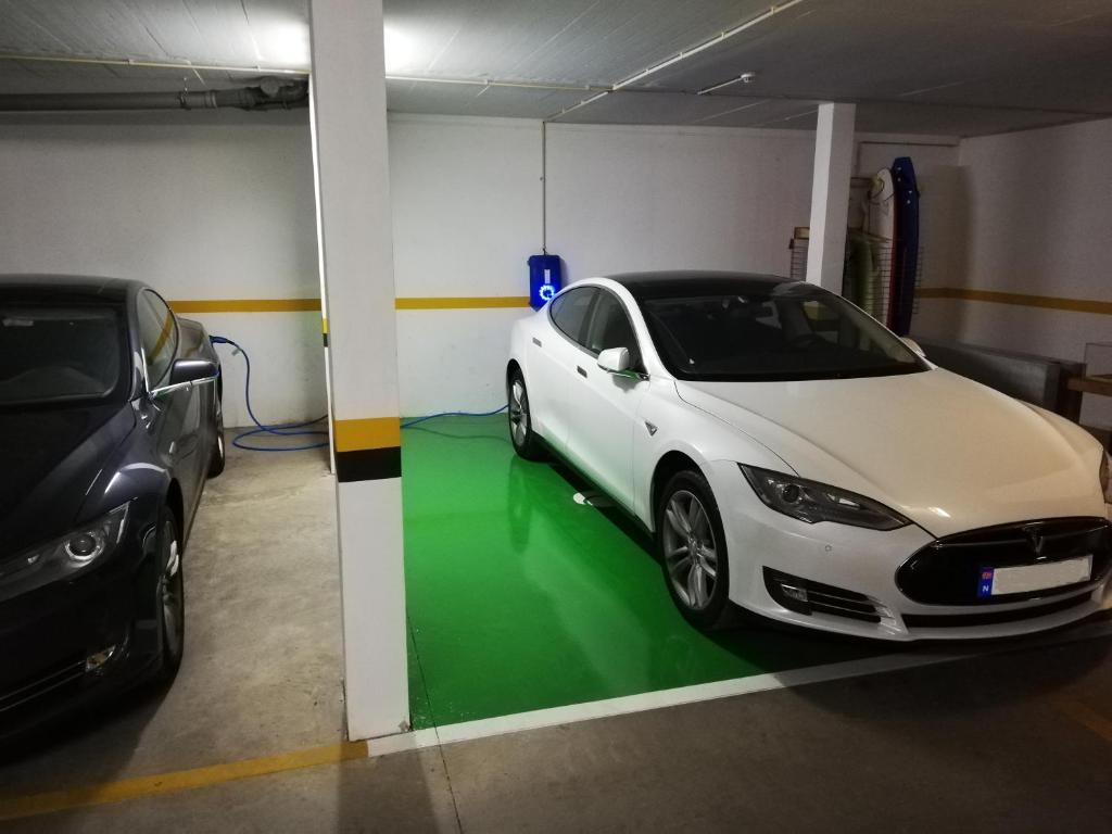 a white car is parked in a garage at Sagres Time Apartamentos in Sagres