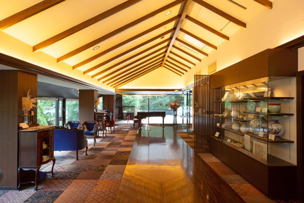 a living room with a long hallway with a table at Hakone Nanase formerly known as Manatei Hakone in Hakone