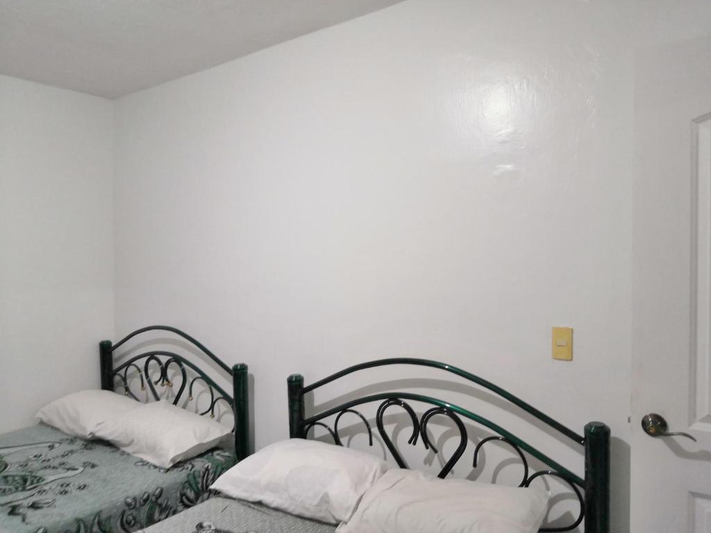 Postel nebo postele na pokoji v ubytování Hostal Maple