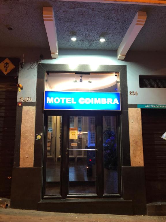 a hotel entrance with a sign on top of it at Motel Coimbra (Adults only) in Belo Horizonte