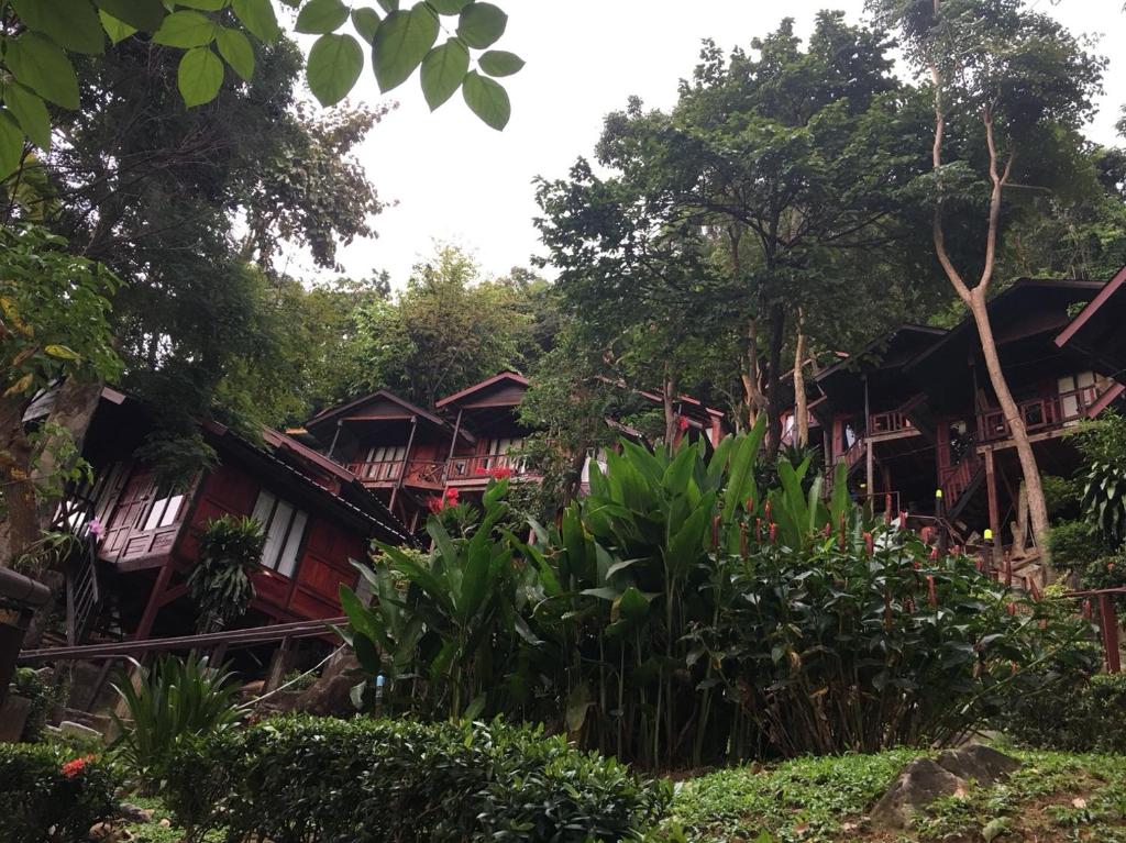 a group of cottages in the trees at Phi Phi Green Hill Resort in Phi Phi Don
