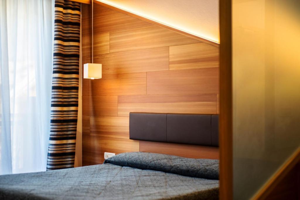 Postel nebo postele na pokoji v ubytování Hotel Al Plan Andalo