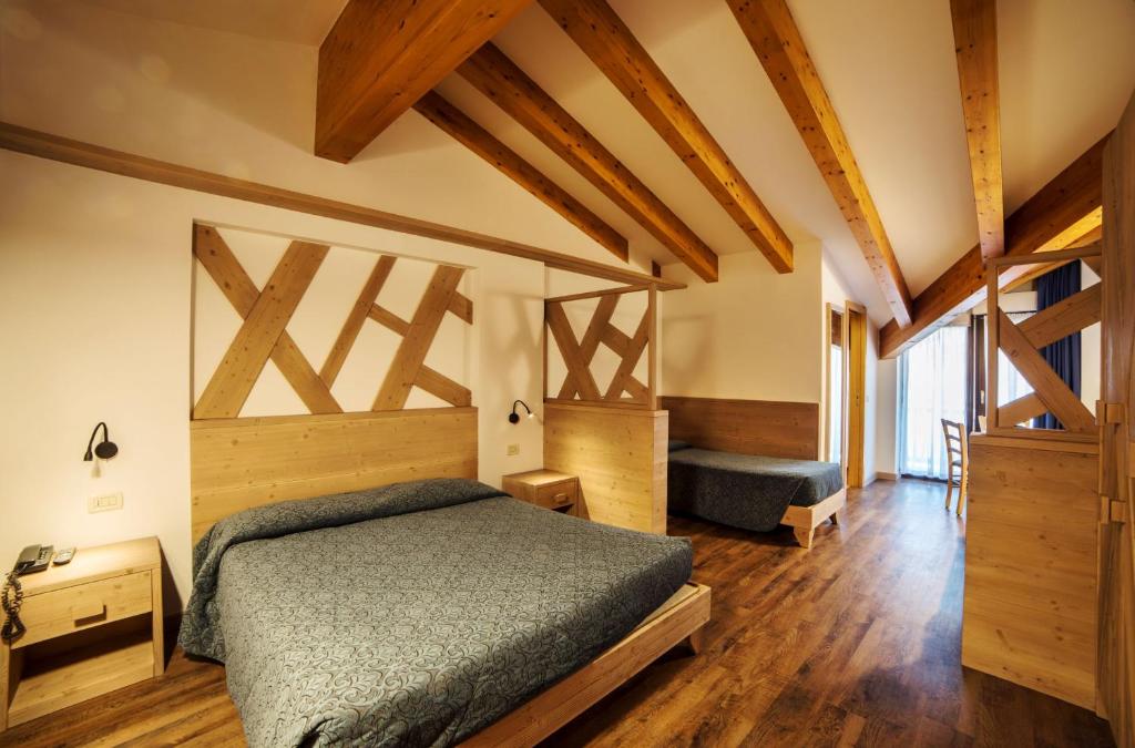 Postel nebo postele na pokoji v ubytování Hotel Al Plan Andalo