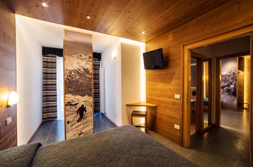 Postel nebo postele na pokoji v ubytování Hotel Al Plan Andalo