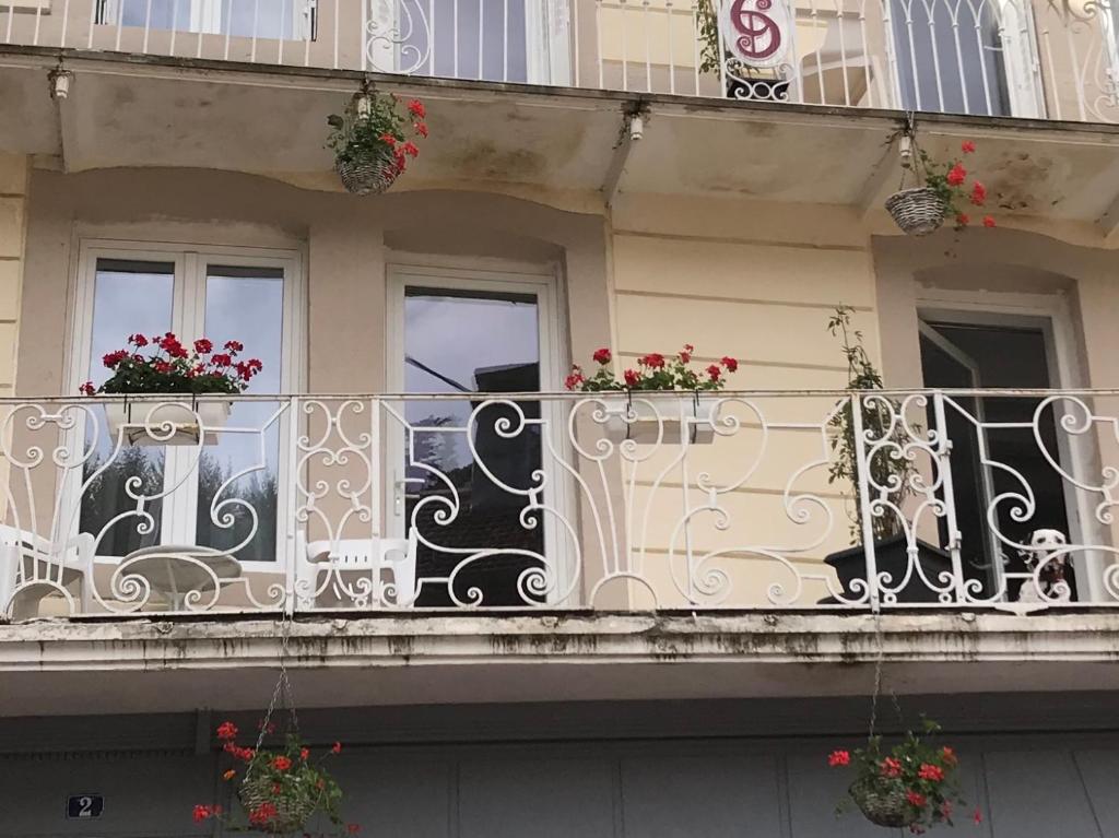 Un balcón de un edificio con flores. en Carpe Diem Résidence en Plombières-les-Bains